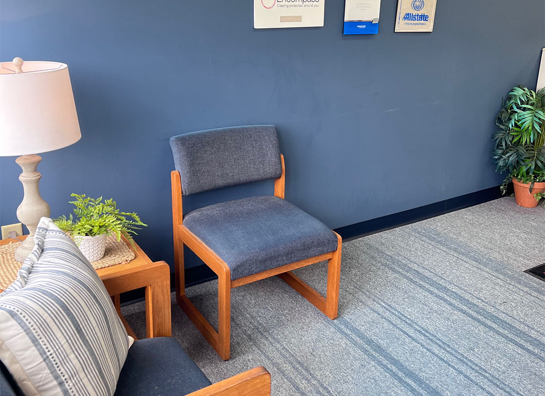 About Our Agency - View of a Waiting Area with Chairs Next to Insurance Company Logos on a Blue Wall Inside the Harry L Bubb Associates Office