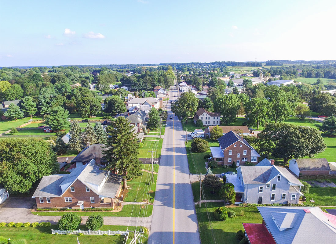 Insurance Solutions - Aerial View of Homes Along a Main Street in Downtown Shrewsbury Pennsylvania Surrounded by Green Trees on a Sunny Day