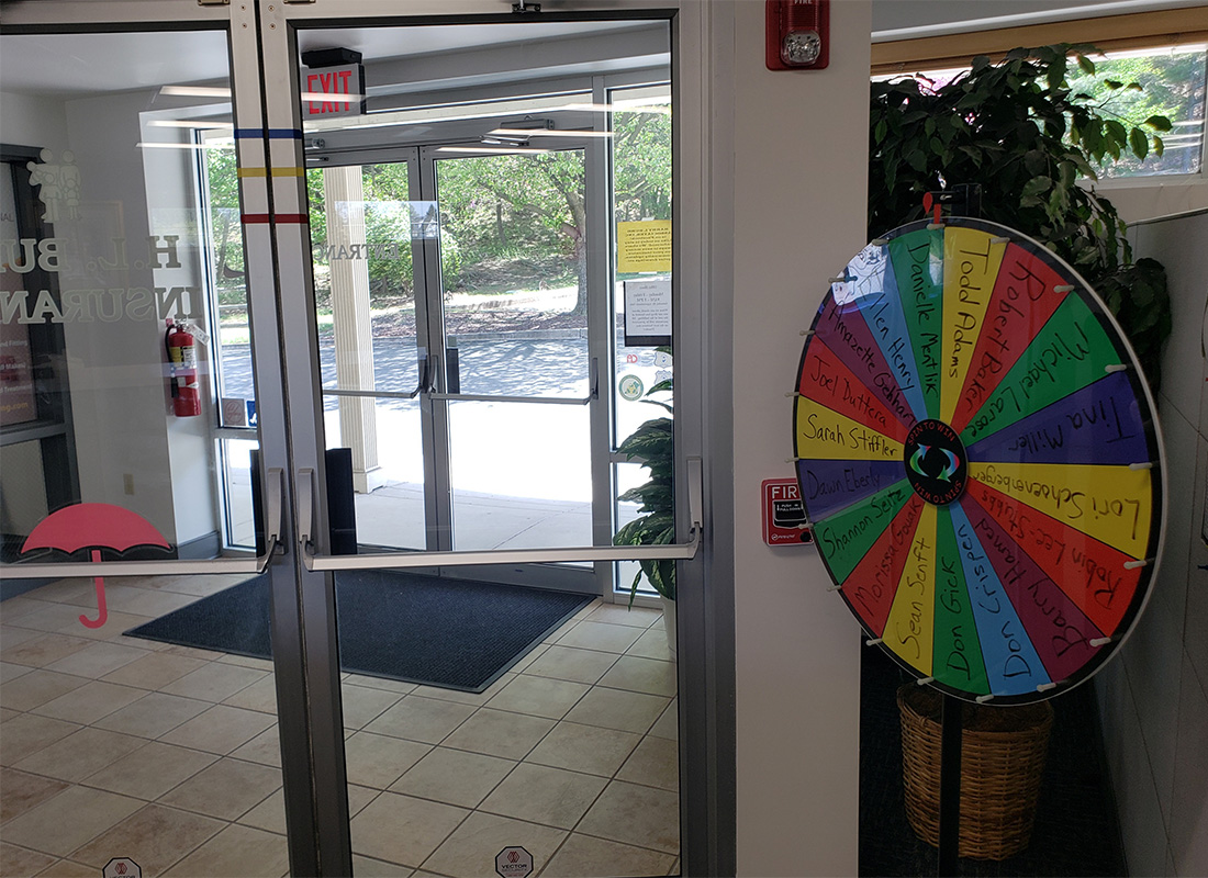 Refer Us - View Inside the Front Entrance of the Bubb Insurance Office Building with a Colorful Spinning Wheel with Names Next to the Doors